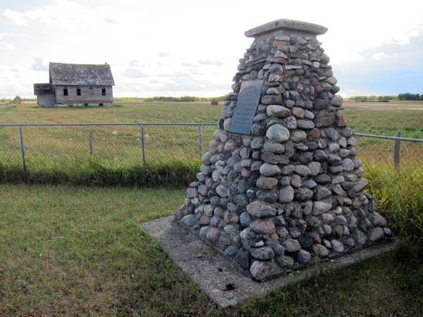 Palmerston pioneers monument with Palmerston Church in the background