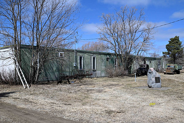 The former Piney Municipal School building with a commemorative monument on the grounds in front of it