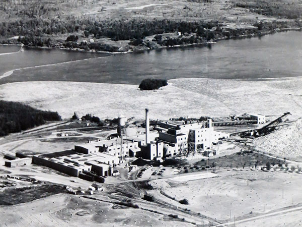 Aerial view of the paper mill at Pine Falls with the Winnipeg River in the background