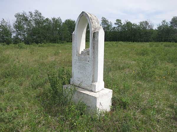 Broken monument beside the church