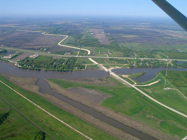 Inlet Control Structure on the Red River, gates submerged, with entrance to Floodway Channel in foreground
