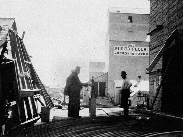 Tornado damage to the Manitoba Pool elevator at Regent, with Western Canada Flour Mills and Lake of the Woods Milling elevators in the background