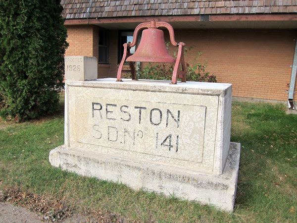 The name plate, bell and cornerstone from Reston Consolidated School are displayed in front of the present school
