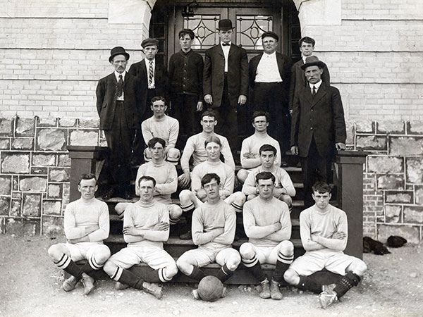 Members of a Rivers football club (CNR Car Department) have their photo taken on the Rivers School steps
