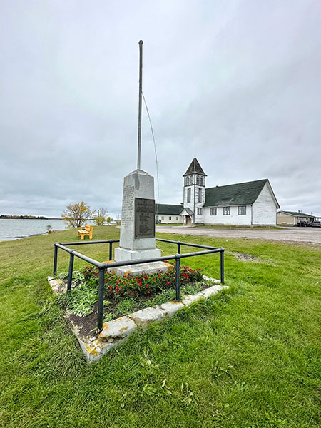 Rossville War Memorial with the former James Evans Memorial United Church in the background