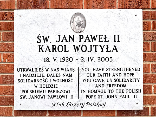 Plaque commemorating Pope John Paul II on the exterior of St. Andrew Bobola Roman Catholic Church