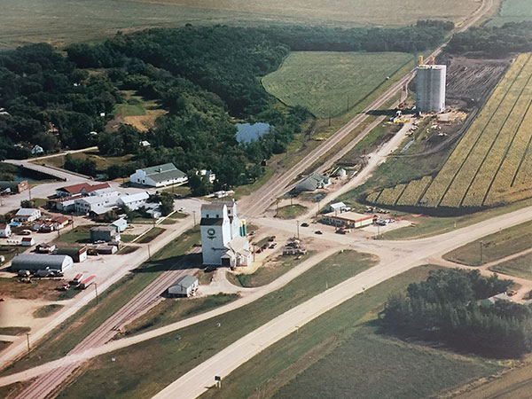 Aerial view of the Starbuck grain elevators with a new concrete replacement under construction in the background