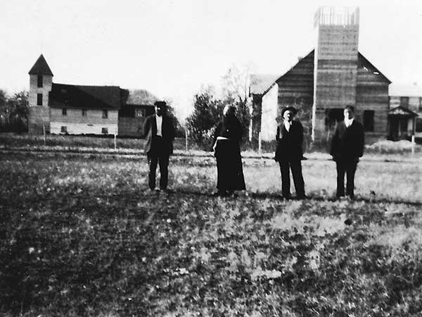 The second Notre Dame Roman Catholic Church at right with the earlier structure at left