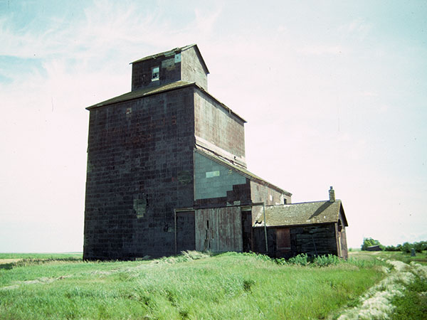 The former Underhill Farmers’ grain elevator at Underhill, with the monument for Barber School visible at the right