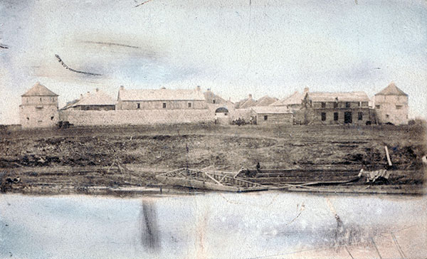 Colorized photo of Upper Fort Garry seen from across the Red River in St. Boniface
