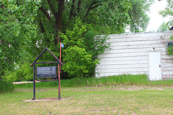 The former West Curtis School building and commemorative monument