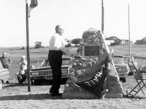Colin More Jr. unveiling the West Hall School commemorative monument