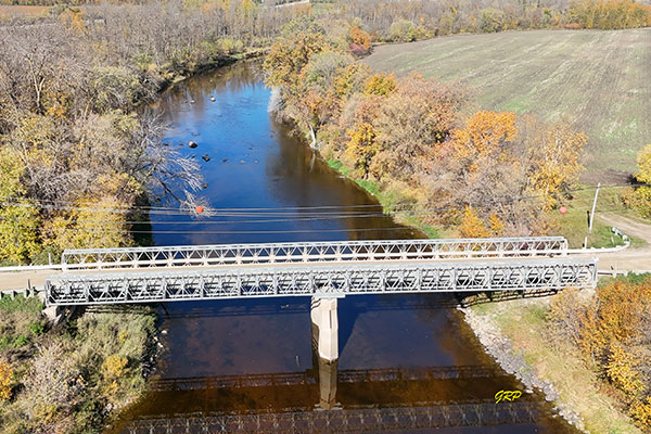 Aerial view of steel pony truss bridge over the Whitemouth River