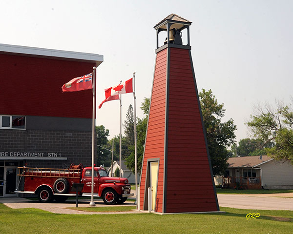 Historic fire truck and bell in front of the Winkler Fire Hall