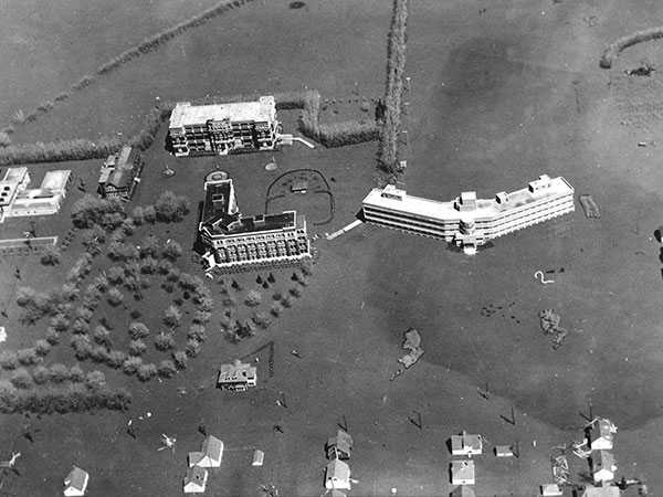 Aerial view of Princess Elizabeth Hospital at right, King George Isolation Hospital at centre, and King George Nurses’ Residence at rear during the 1950 Winnipeg Flood