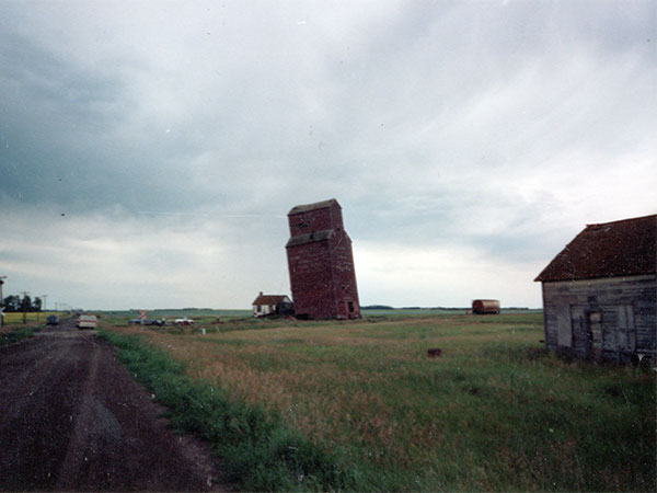 The former Wood Bay grain elevator prior to demolition, with the former Wood bay store and post office at right