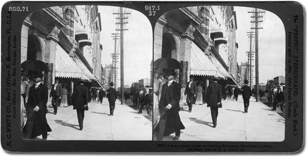 Pedestrians on the west side of Main Street immediately north of Portage Avenue