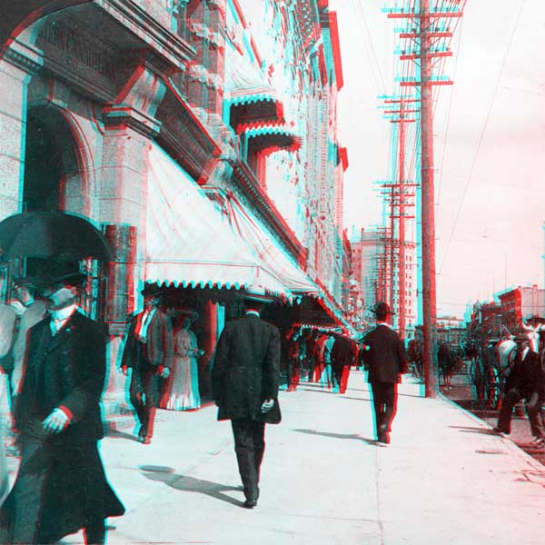 Pedestrians on the west side of Main Street immediately north of Portage Avenue
