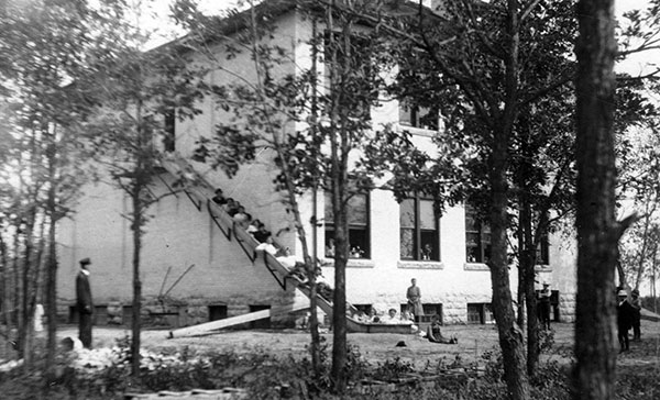 Fire drill. The new Starbuck Consolidated School building boasted a chute from the second floor to get students to safety in the event of a fire, demonstrated in this photo from 1911.
