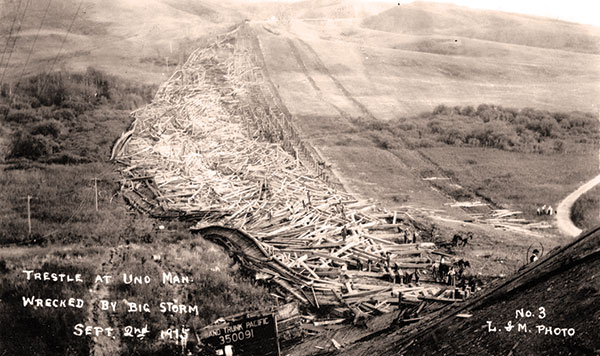 View of the former Uno Bridge taken shortly after its destruction, with the derailed locomotive tender in the foreground.
