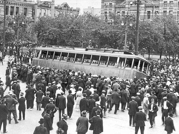 Crowd tips a streetcar on Bloody Saturday