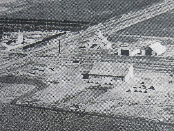 Aerial view of the Hoffman family farm including the grain elevator and mill at the centre rear