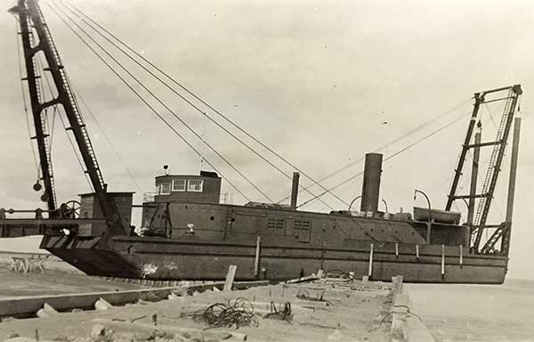 The Port Nelson dredge, lifted onto the artificial island by a storm in November 1924